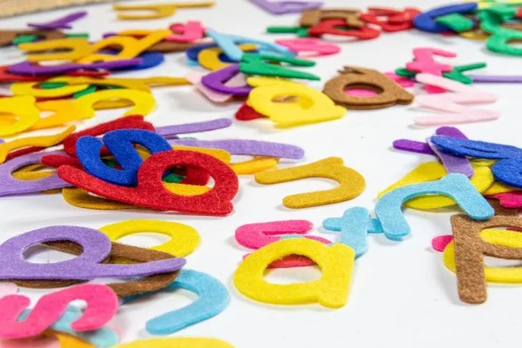 Colorful alphabets scattered on white background
