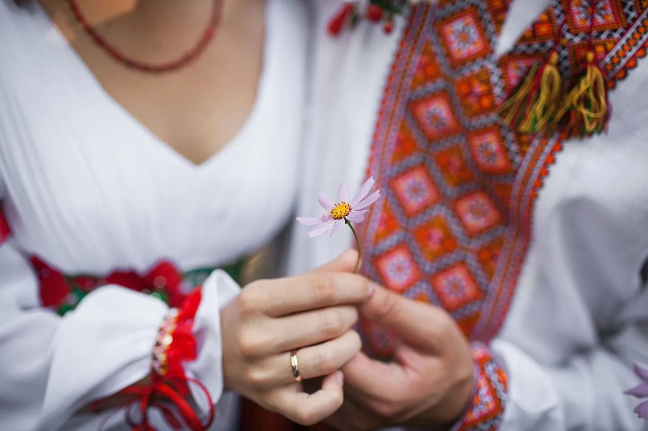 Ukrainian girl holding a pink flower in her hand