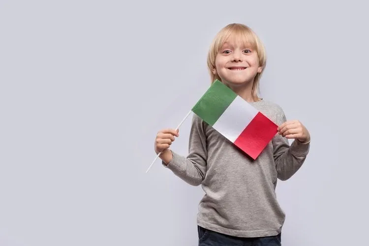 Happy boy holding flag of Italy 