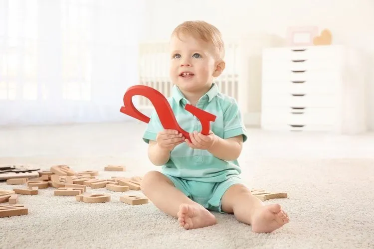 Cute little child with letter S at home