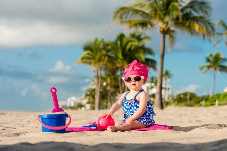 A baby girl enjoying on a beach