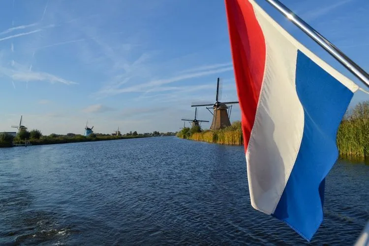 Windmills at Kinderdijk, Netherlands with the Dutch flag