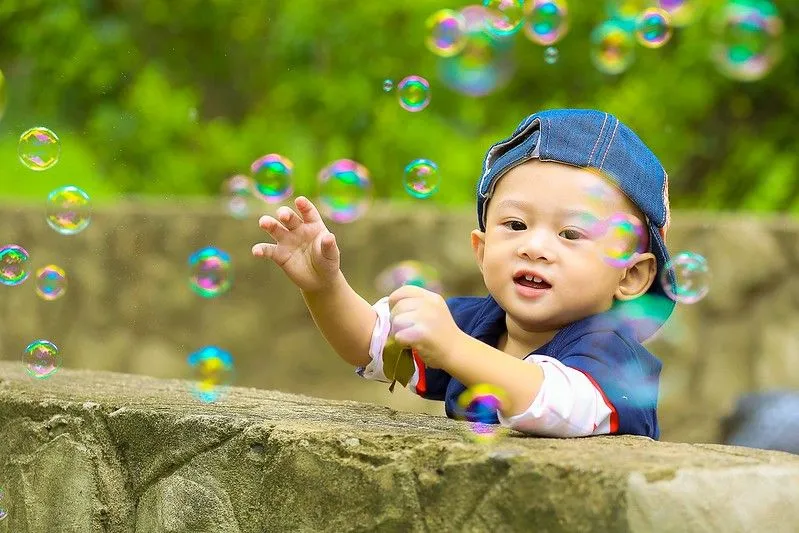 Child playing with bubbles