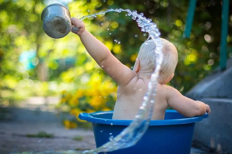 Baby playing in bucket