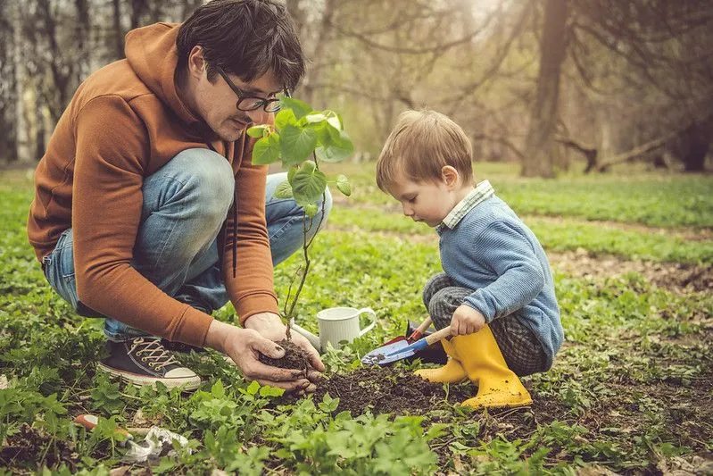 Child gardening with parent