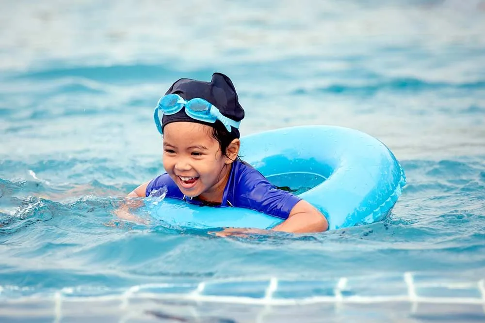 child swimming in rubber ring