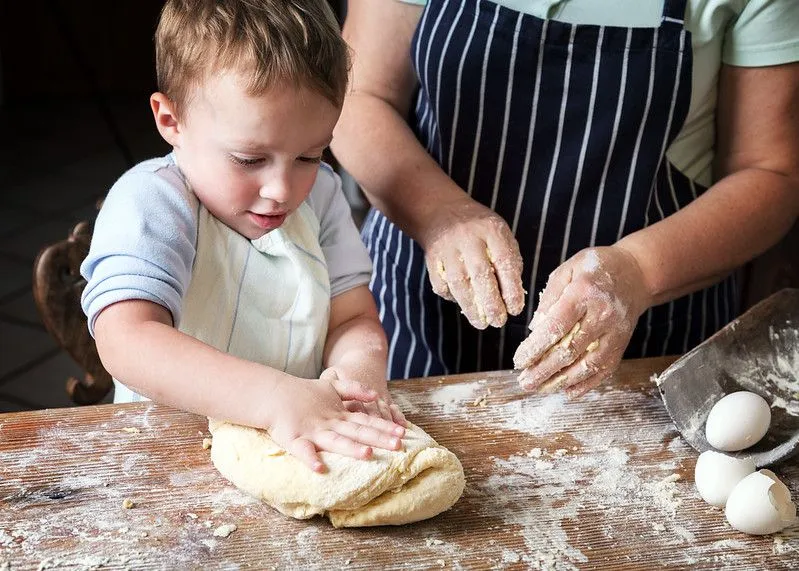 Child baking with parent