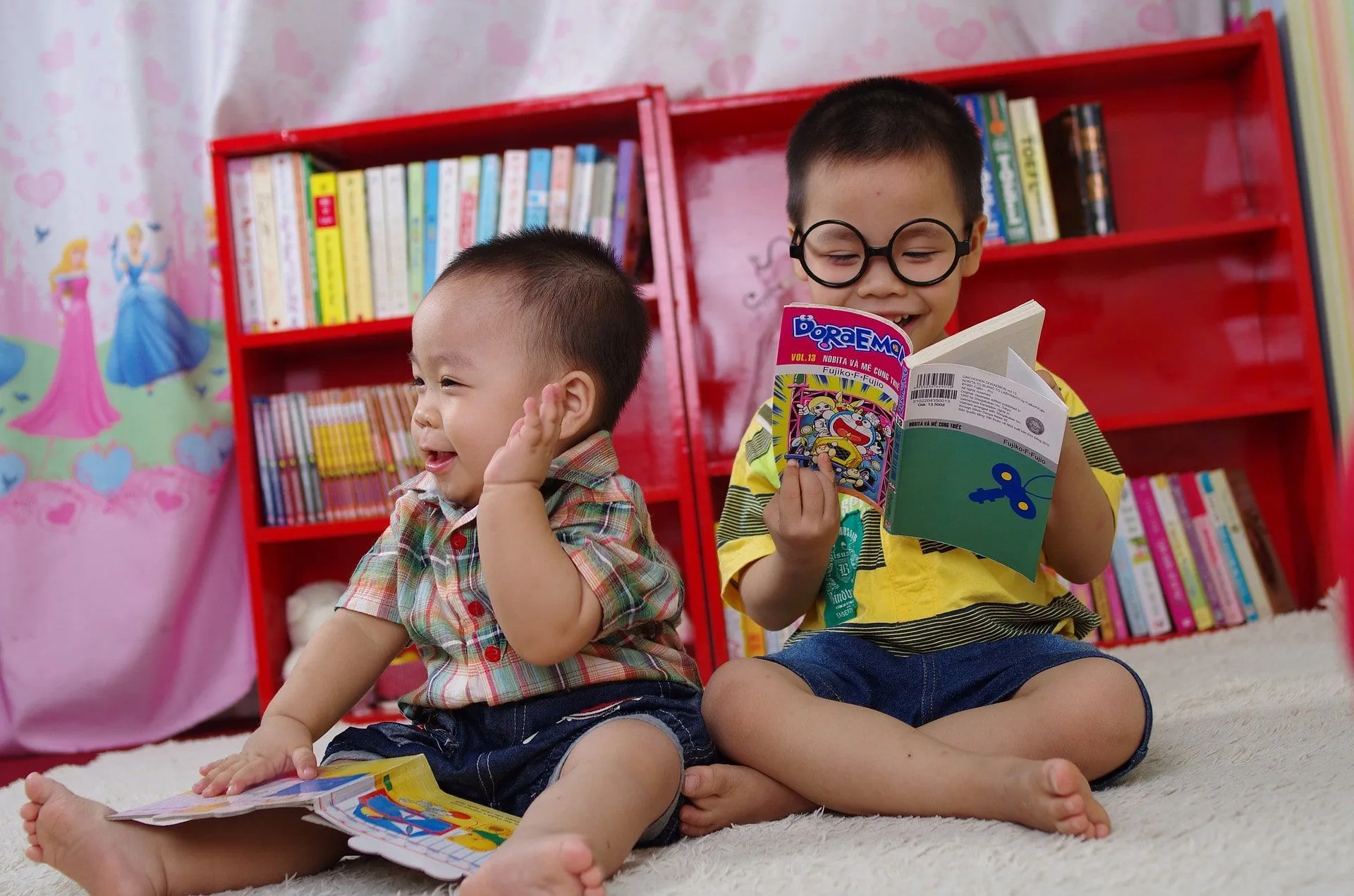 two brothers sat on floor reading