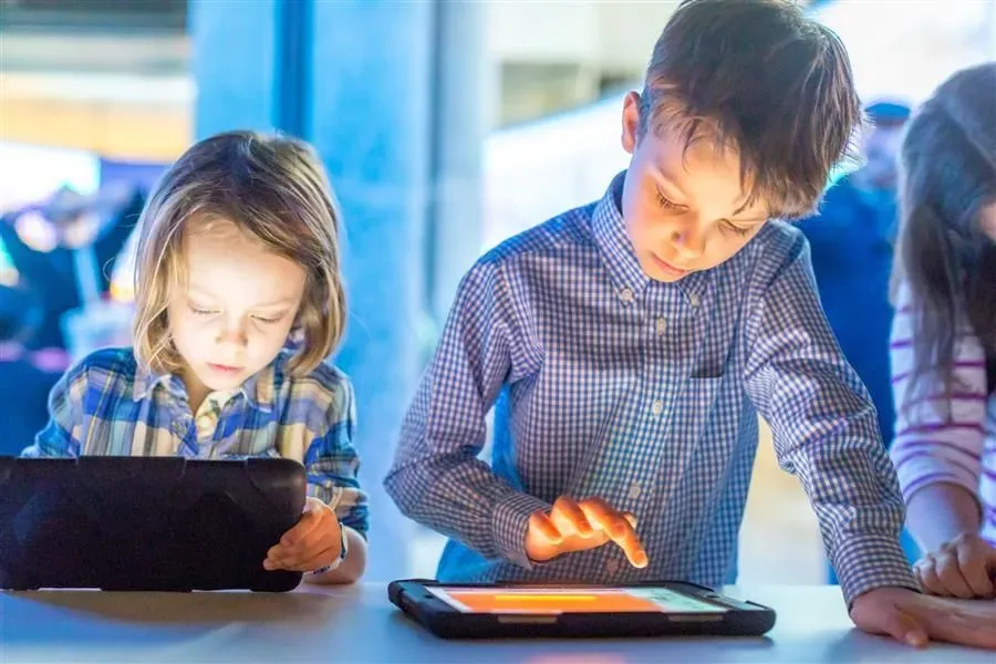 brothers using tablets to practise coding