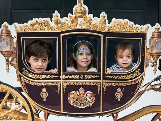 three children in royal carriage