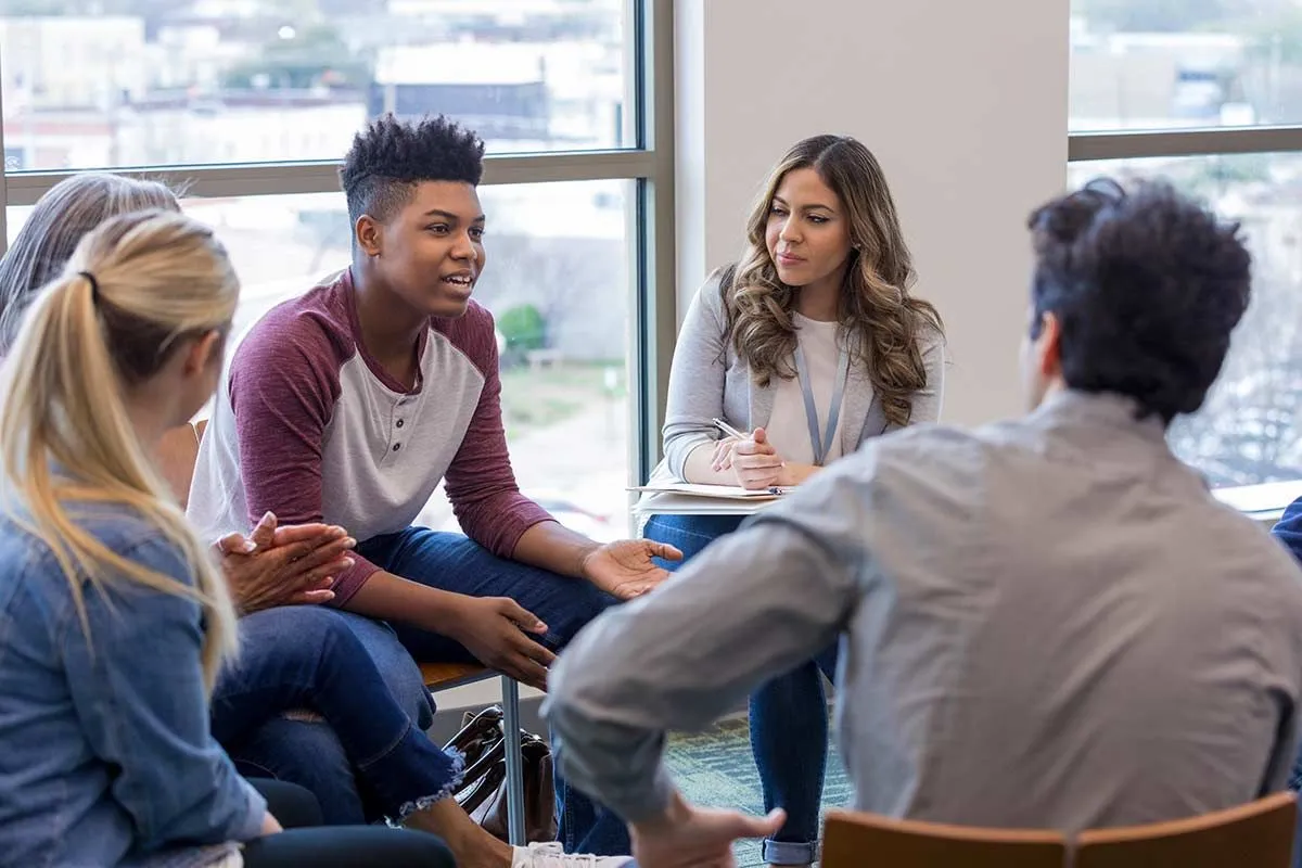 Teens sat in a circle debating a contentious topic.