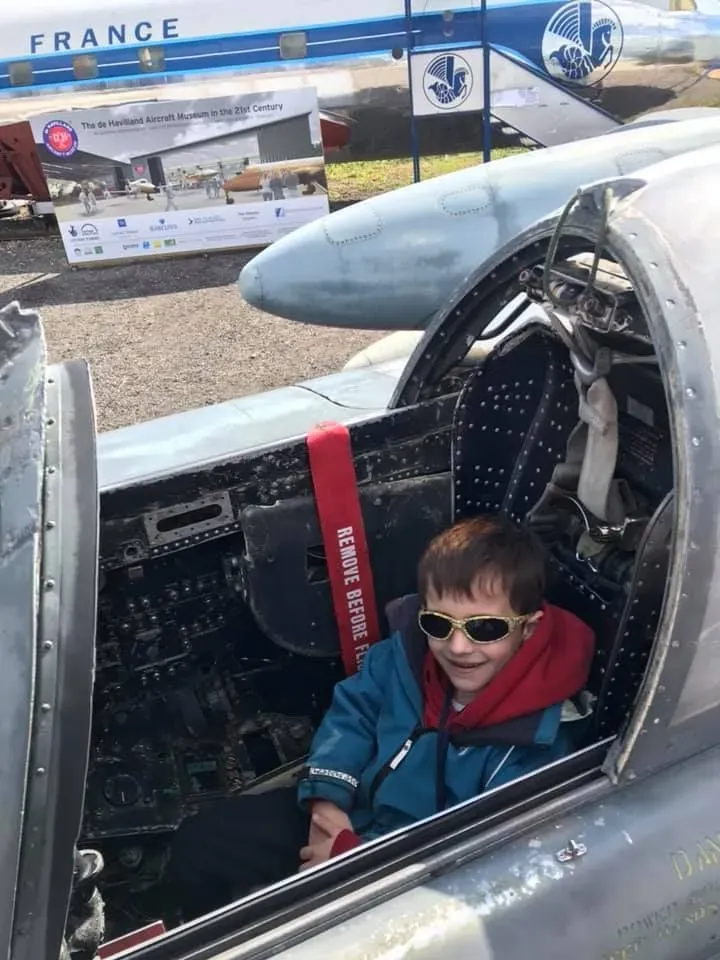 Young boy sitting in an aircraft at the DDe