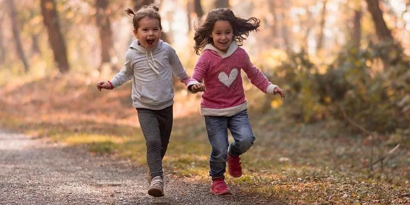Little girls playing in the woods