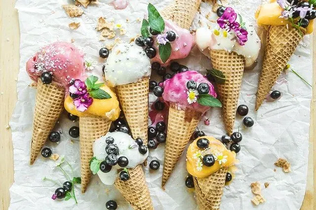 delicious ice cream cones with melted ice cream and blueberries