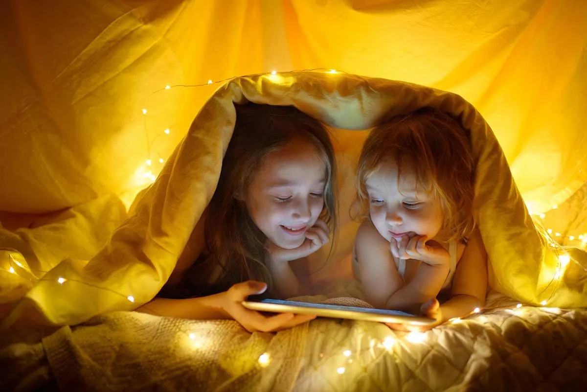 Telling stories under a blanket tent.