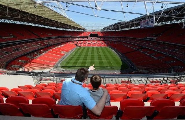 A father and son looking out to the Wembley Stadium pitch