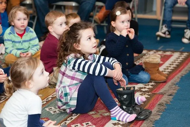 Boys and girls attentively listening to a story 