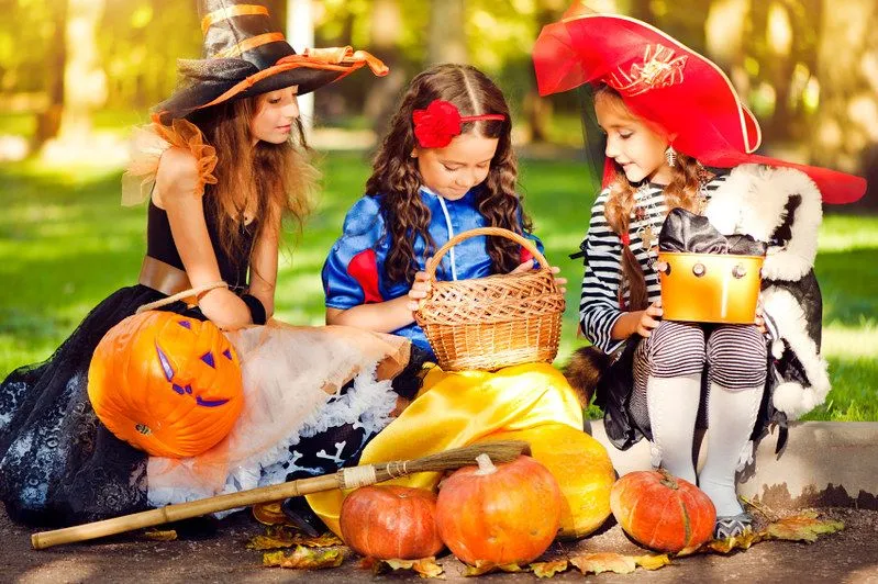 Girls dressed up for creating Halloween decorations.