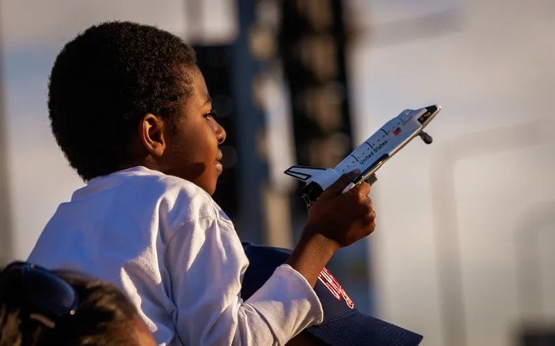 Young boy holding a toy plane