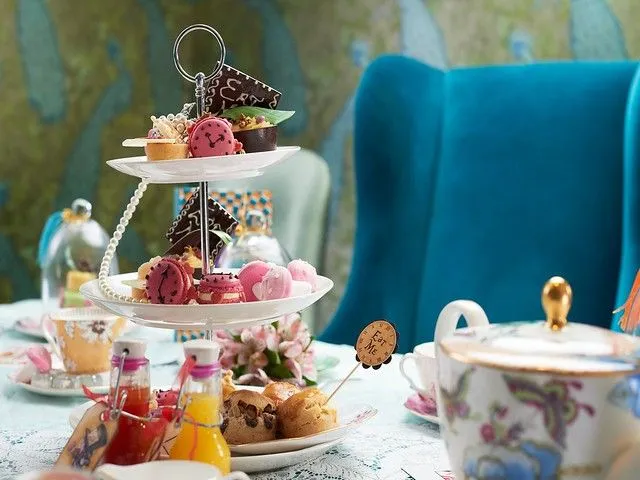 Selection of pastries and cakes on a stand for the Alice in Wonderland Tea at the Taj Hotel