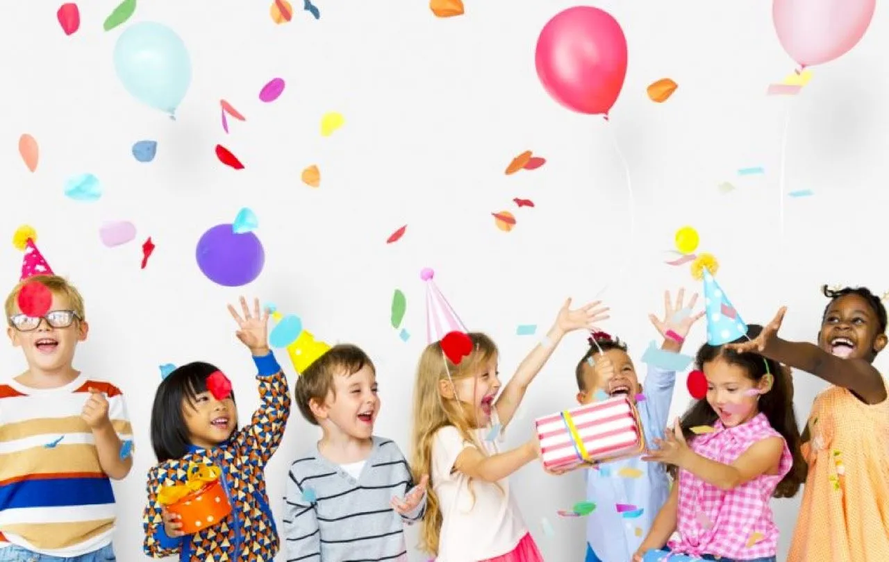 children throwing confetti and balloons