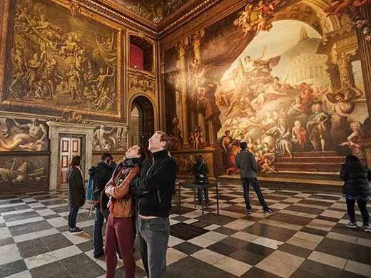 two adults marvelling at the greenwich attraction the painted hall