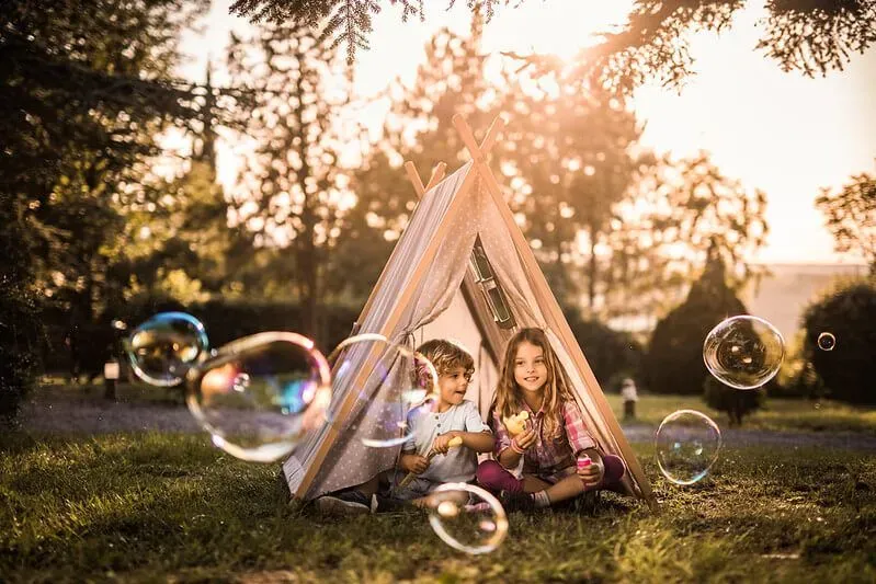 Making a tent and playing with bubbles in the garden.