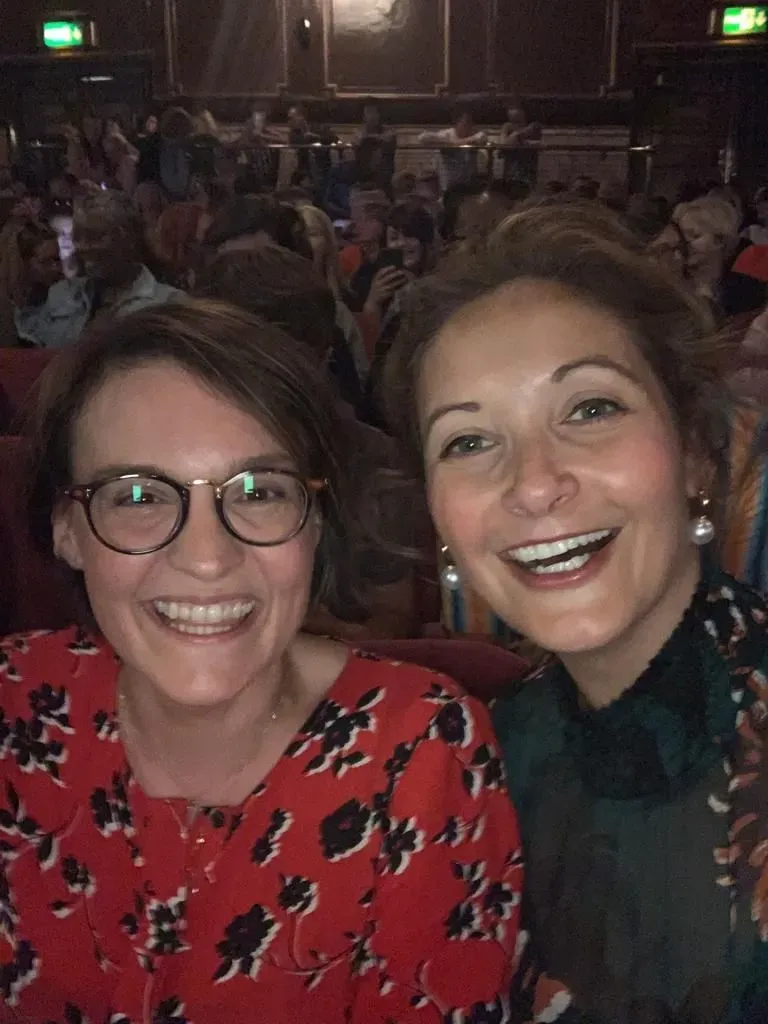 Two women smiling at The London Palladium 
