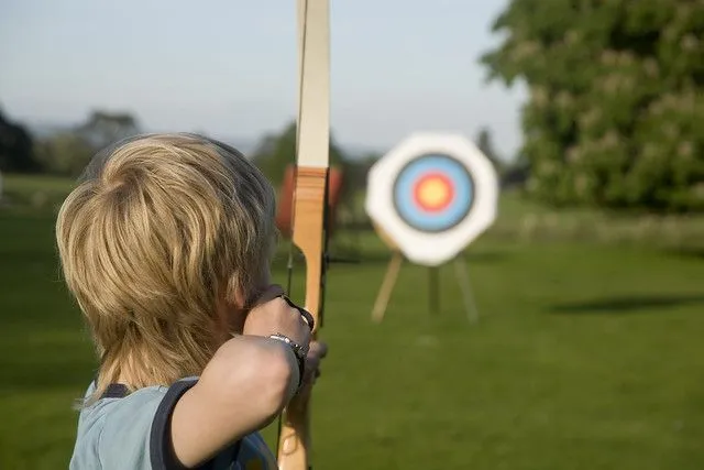 Boy playing the sporting activity of archery