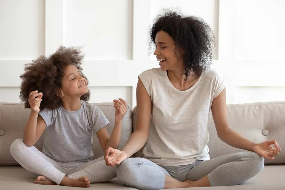 mother and daughter meditating