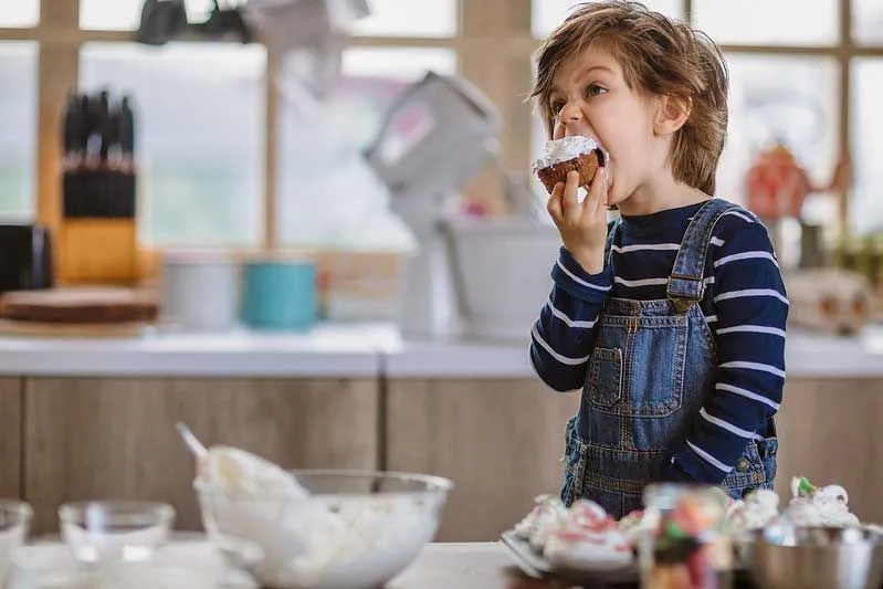 child eating cupcake