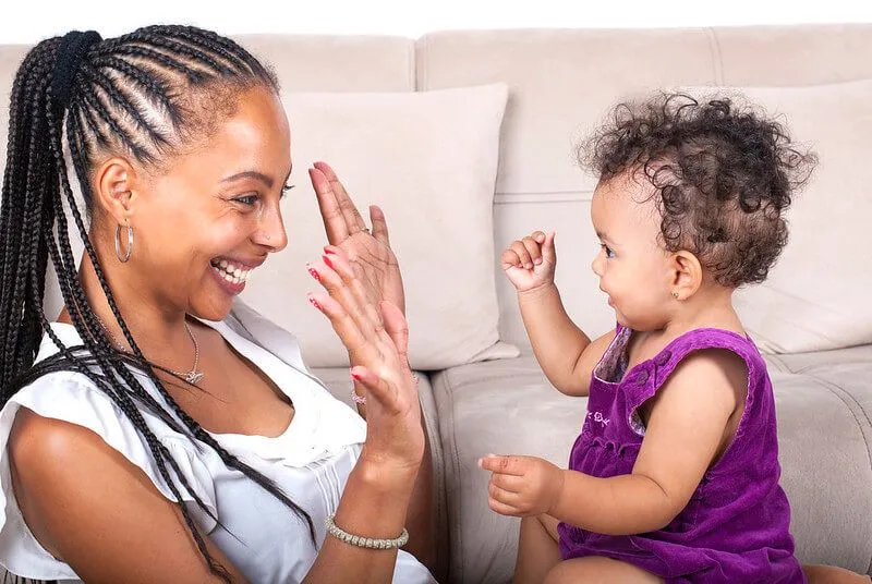 Parent teaching baby sign language