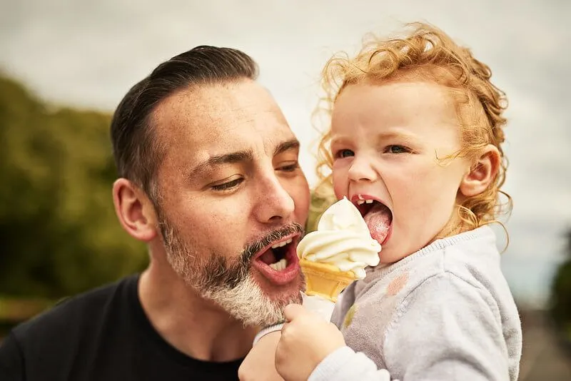 Father and son eating an ice cream