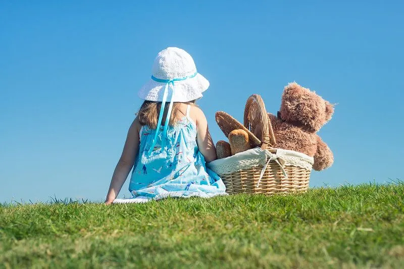 girl having a teddy bear's picnic 
