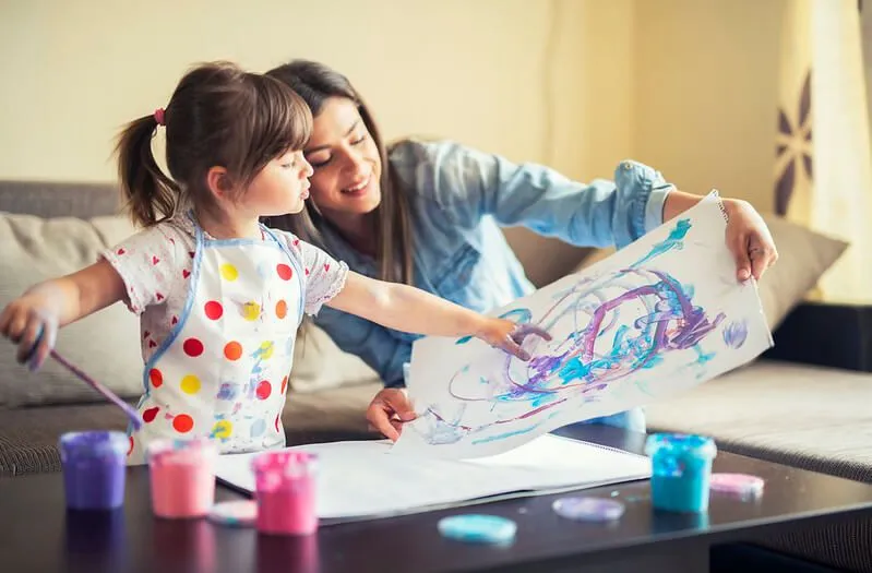 mother helping young child to make a famous art copy kids project