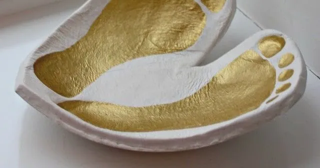 Close up of a baby foot print ornament heart-shaped bowl.