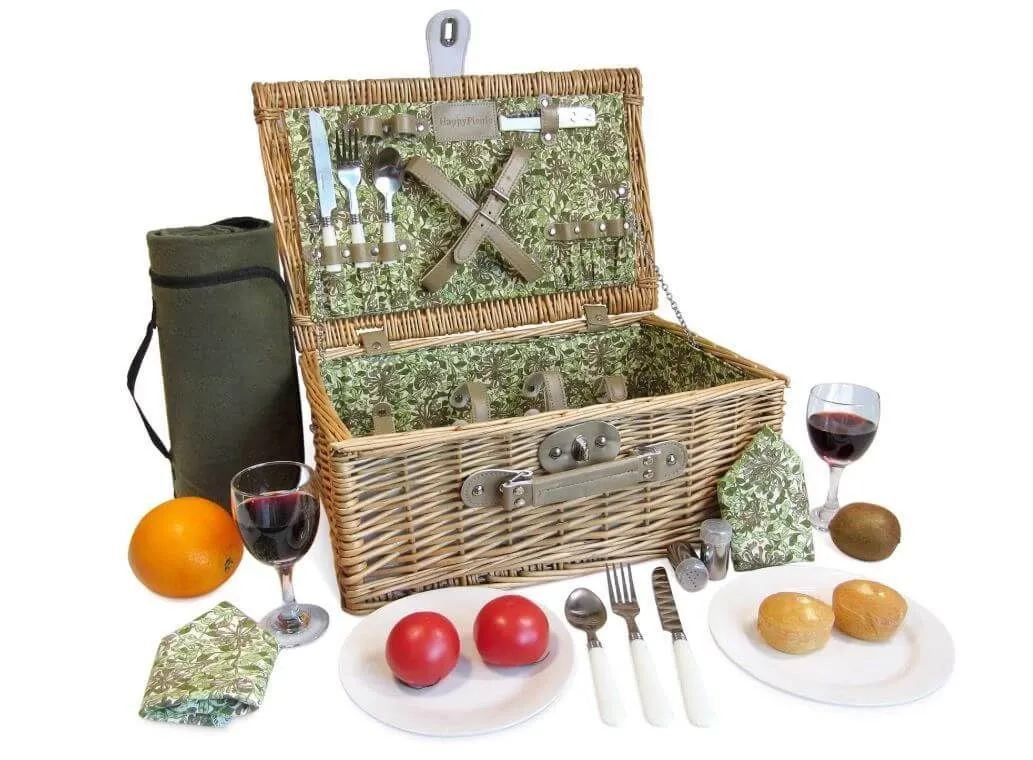 open floral picnic basket surrounded by plates and glasses