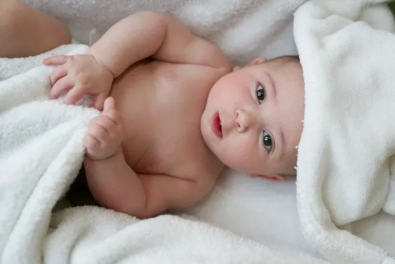 Baby lying on towels after having a baby bath