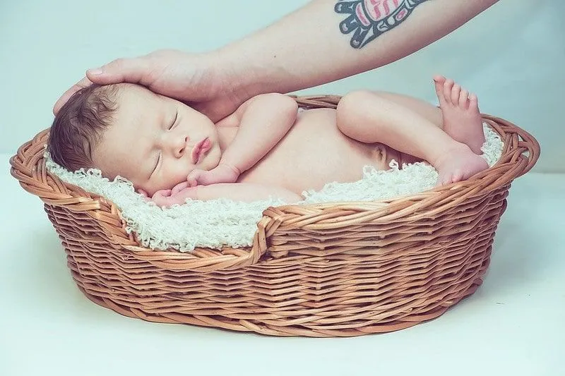 Baby sleeping in wicker basket
