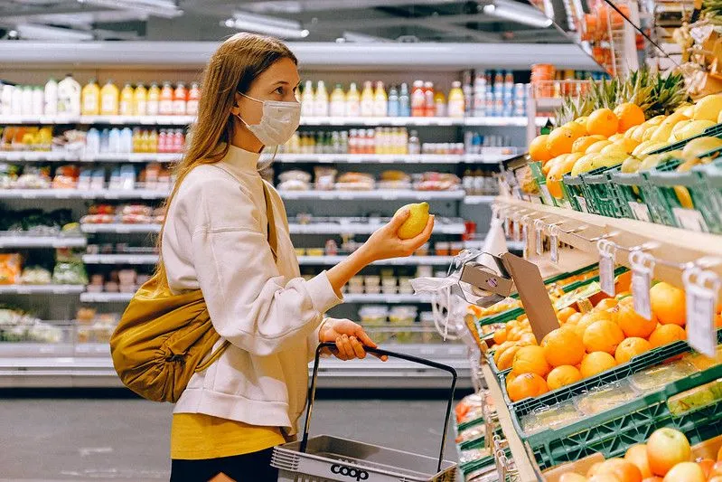 Teenager buying fruit while on holiday this summer