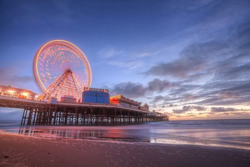 Blackpool pier lit up at sunset.