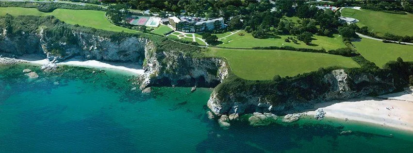 View from above of the luxury Carlyon Bay Hotel on cliff edge overooking the sea, Cornwall.