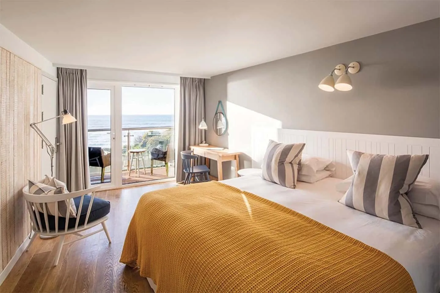 Luxury nautical-themed bedroom overlooking the Cornwall beach.