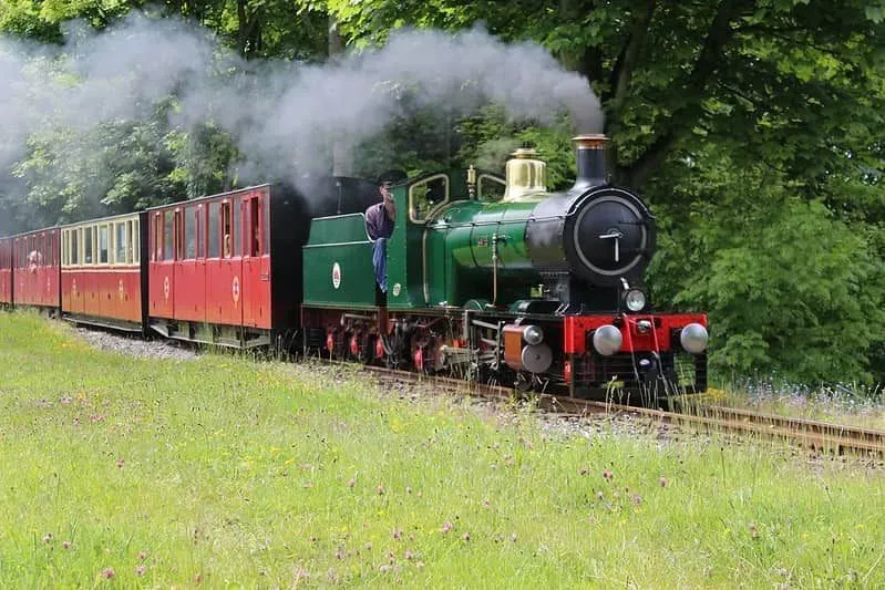 Colourful steam train moving along at Kirklees Light Railway.
