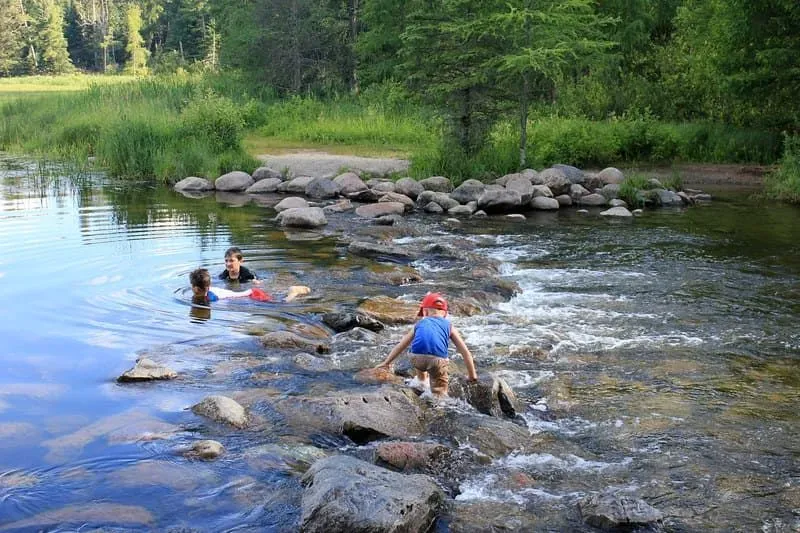 Children playing with stones in a river