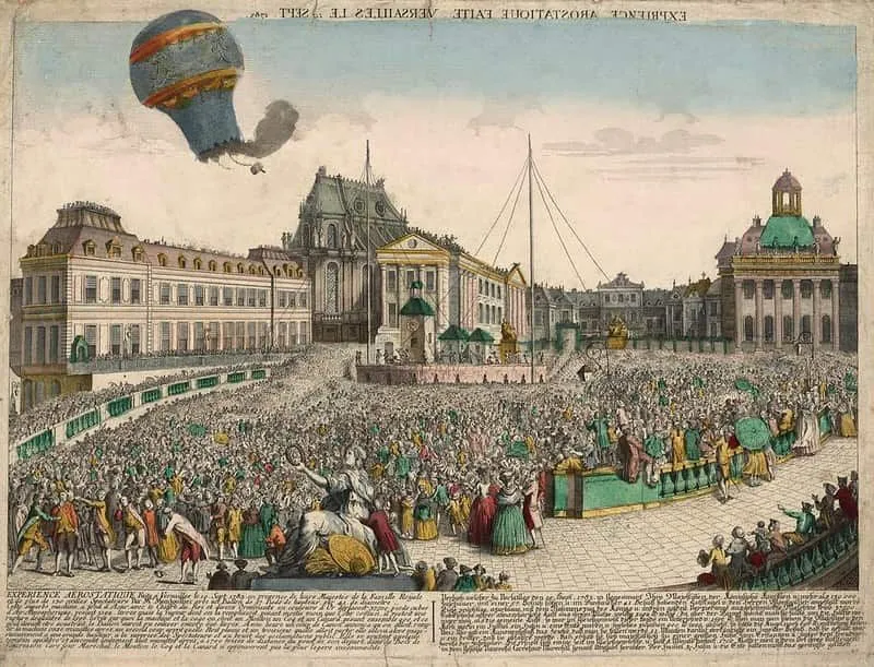 Old image of a hot air balloon gone wrong, burning above the crowd.