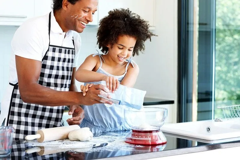 Dad Helping Daughter Bake Cake.