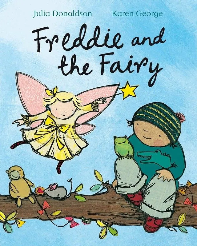 Cover of Freddie And The Fairy: Freddie is sat on a tree branch with some animals, and a fairy is beside him in the sky, pointing her magic wand.