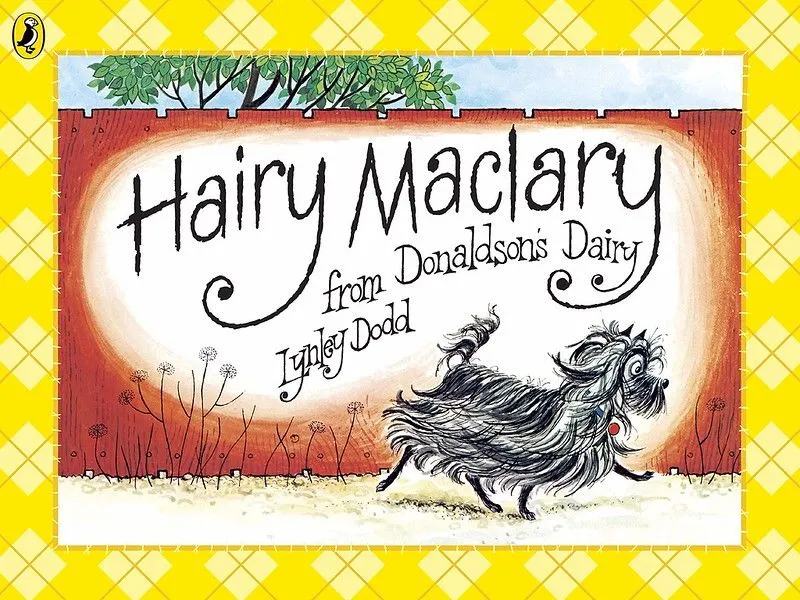Cover of Hairy Maclary: a black dog with a long coat is walking down a path, with a tall red fence behind it.