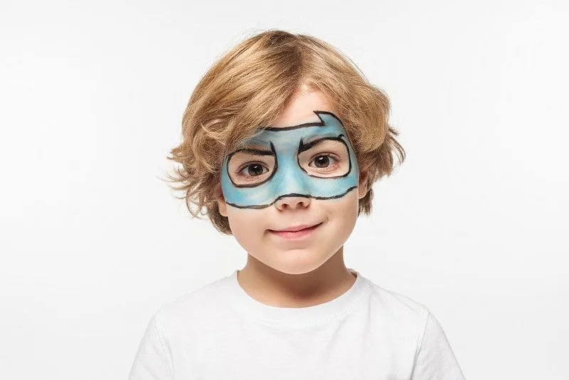 Boy with face paint of a blue batman mask.